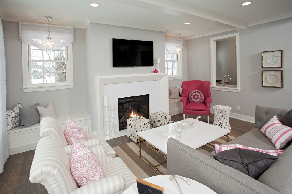 This is an example of a mid-sized beach style enclosed living room in Minneapolis with grey walls, a standard fireplace and a wall-mounted tv.