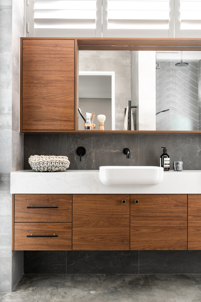 Design ideas for a mid-sized contemporary master bathroom in Perth with medium wood cabinets, gray tile, porcelain tile, grey walls, concrete floors, engineered quartz benchtops, grey floor, a hinged shower door and white benchtops.