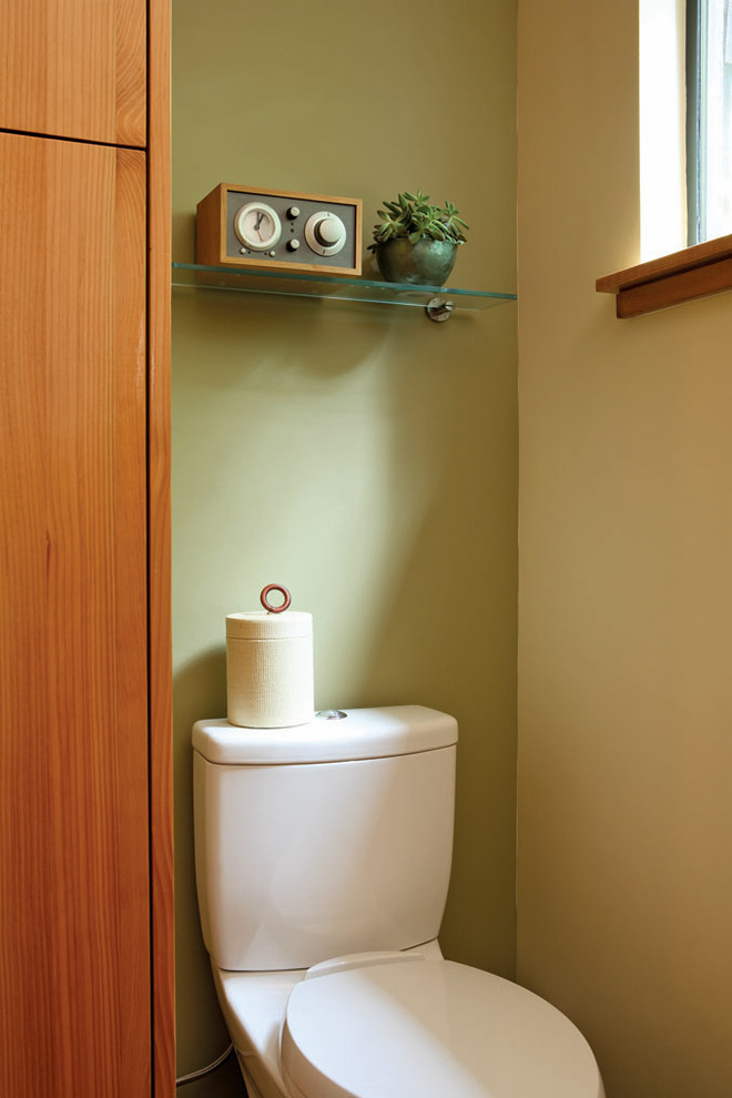 This is an example of a mid-sized contemporary 3/4 bathroom in San Francisco with flat-panel cabinets, medium wood cabinets, a corner shower, a two-piece toilet, brown tile, green tile, green walls, slate floors and a drop-in sink.