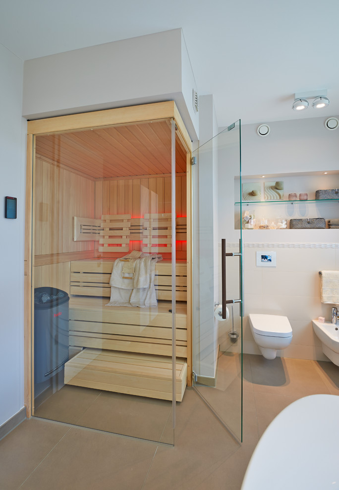 This is an example of a large contemporary bathroom in Other with a wall-mount toilet, white tile, white walls, ceramic tile, ceramic floors and with a sauna.