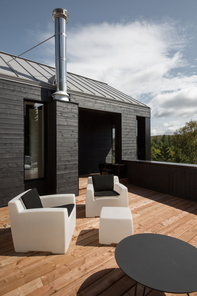 This is an example of a mid-sized contemporary rooftop deck in Montreal with no cover.