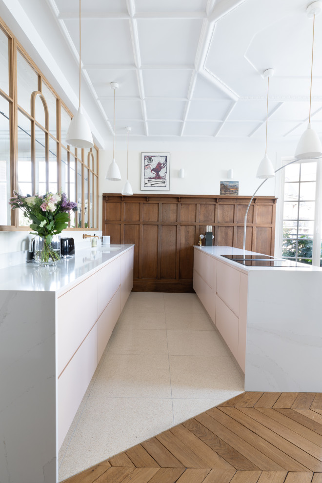 Design ideas for a large transitional galley open plan kitchen in Paris with a single-bowl sink, beaded inset cabinets, pink cabinets, quartzite benchtops, white splashback, engineered quartz splashback, panelled appliances, terrazzo floors, with island, beige floor, white benchtop and coffered.