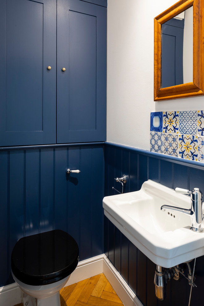 Inspiration for a traditional powder room in London with shaker cabinets.