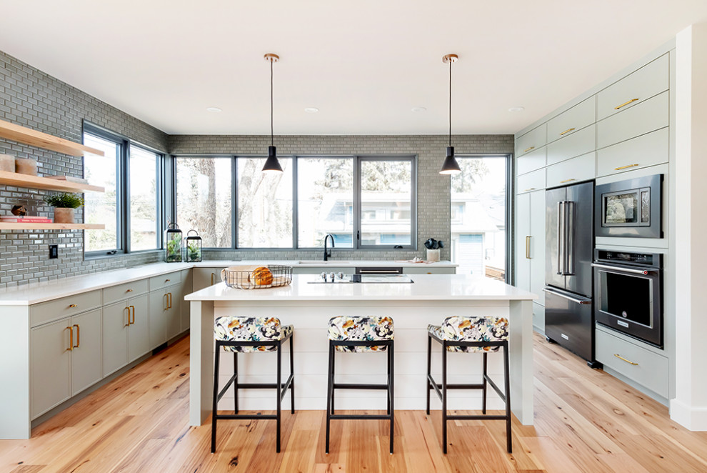 Midcentury kitchen in Other with flat-panel cabinets, green cabinets, engineered quartz splashback, light hardwood floors, brown floor, white benchtop and exposed beam.