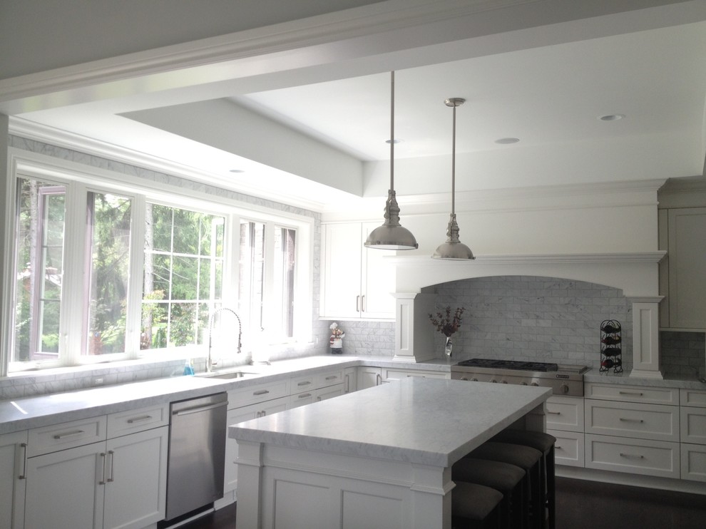Mid-sized transitional u-shaped medium tone wood floor eat-in kitchen photo in Detroit with a single-bowl sink, recessed-panel cabinets, white cabinets, marble countertops, gray backsplash, subway tile backsplash, stainless steel appliances and an island