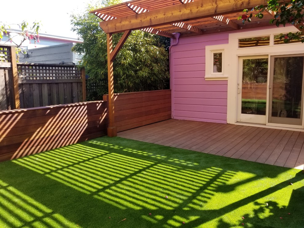 Inspiration for a small transitional backyard patio in San Francisco with decking and a pergola.