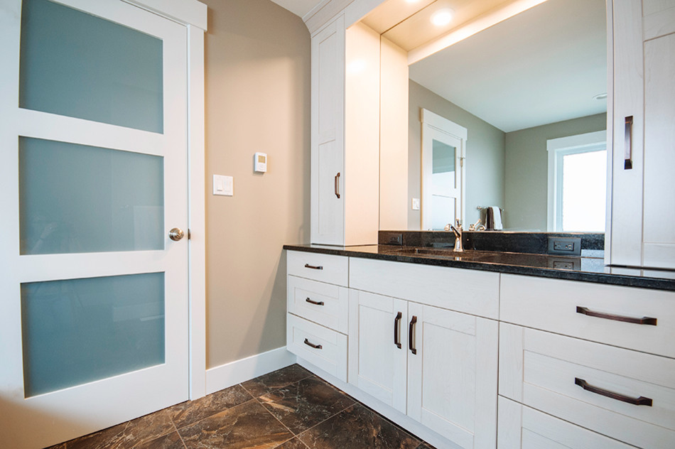 Inspiration for a mid-sized transitional master bathroom in Edmonton with an undermount sink, shaker cabinets, white cabinets, granite benchtops, a drop-in tub, a corner shower, a two-piece toilet, multi-coloured tile, ceramic tile and brown walls.
