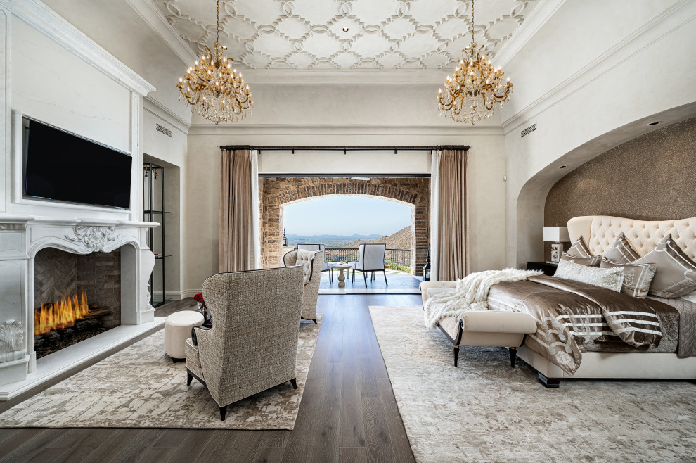 Inspiration for a huge master medium tone wood floor and coffered ceiling bedroom remodel in Phoenix with a standard fireplace and a stone fireplace