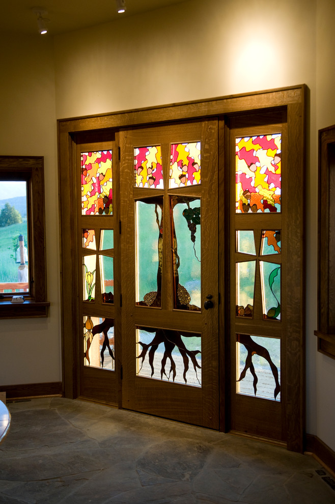 Inspiration for a large rustic slate floor front door remodel with beige walls and a glass front door