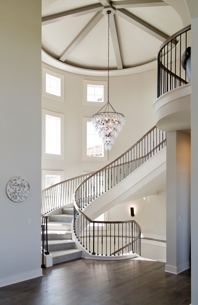 Design ideas for a large eclectic carpeted spiral staircase in Kansas City with carpet risers and mixed railing.