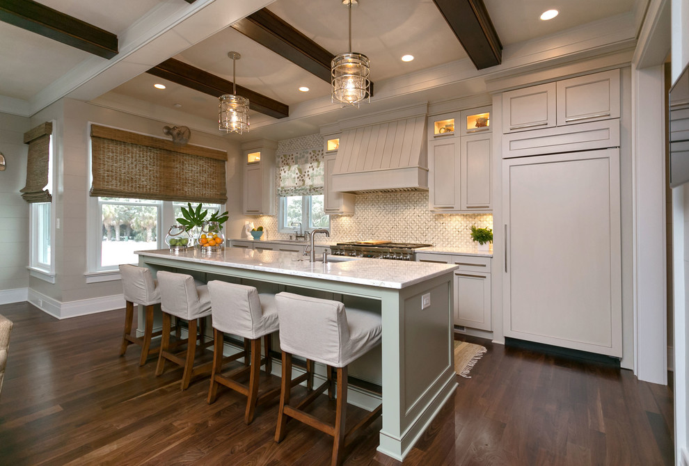 Beach style galley kitchen in Charleston with an undermount sink, recessed-panel cabinets, white cabinets, white splashback and panelled appliances.