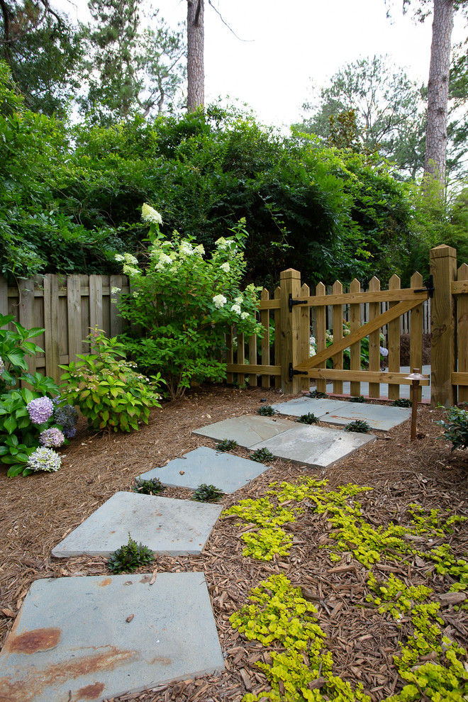 This is an example of a traditional garden in Atlanta with natural stone pavers.