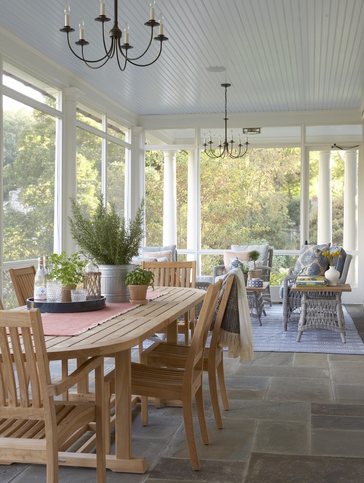 Inspiration for a large timeless stone screened-in back porch remodel in New York with a roof extension