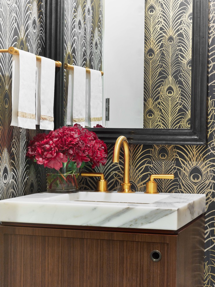 Inspiration for a small eclectic powder room in New York with an undermount sink and marble benchtops.