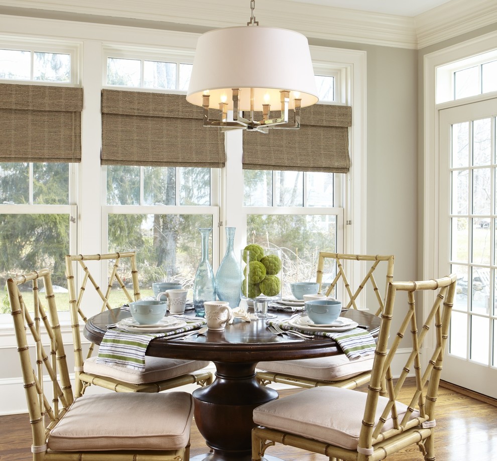 Photo of a beach style dining room in New York with grey walls and medium hardwood floors.