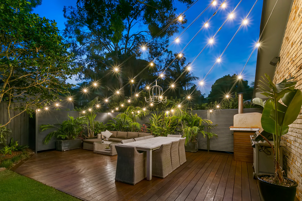 Contemporary backyard deck in Sydney with no cover.