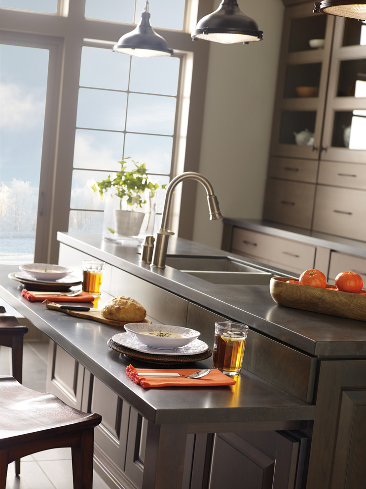 Open concept kitchen - large transitional single-wall porcelain tile open concept kitchen idea in Toronto with a double-bowl sink, flat-panel cabinets, dark wood cabinets, soapstone countertops, brown backsplash, ceramic backsplash, stainless steel appliances and an island