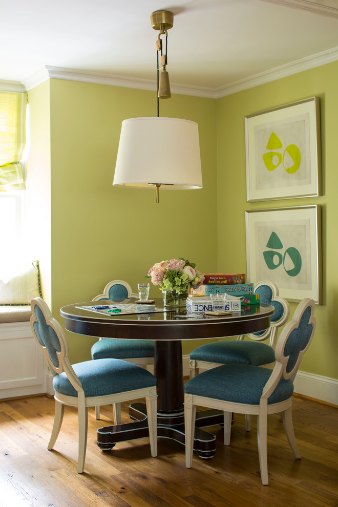 Photo of a transitional dining room in Baltimore with green walls and medium hardwood floors.
