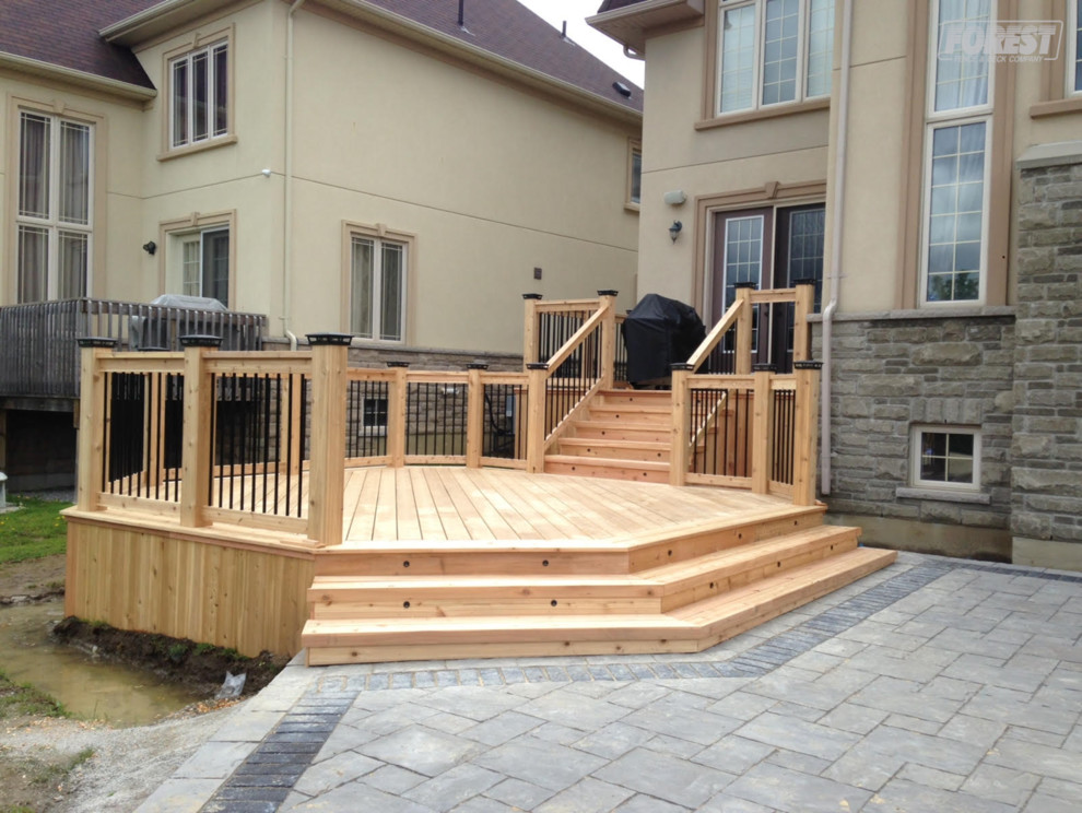 Example of a mid-sized mountain style backyard deck design in Toronto