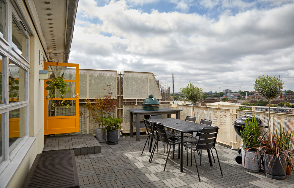 Large midcentury metal railing balcony in London with no cover and a bbq area.