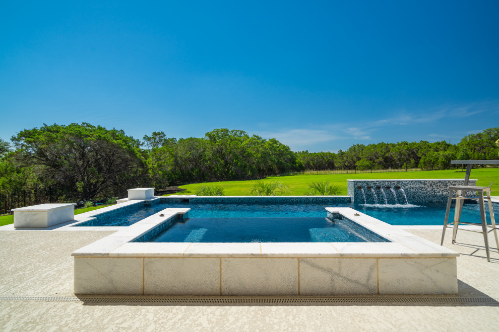 Photo of a large modern back custom shaped swimming pool in Other with decking.