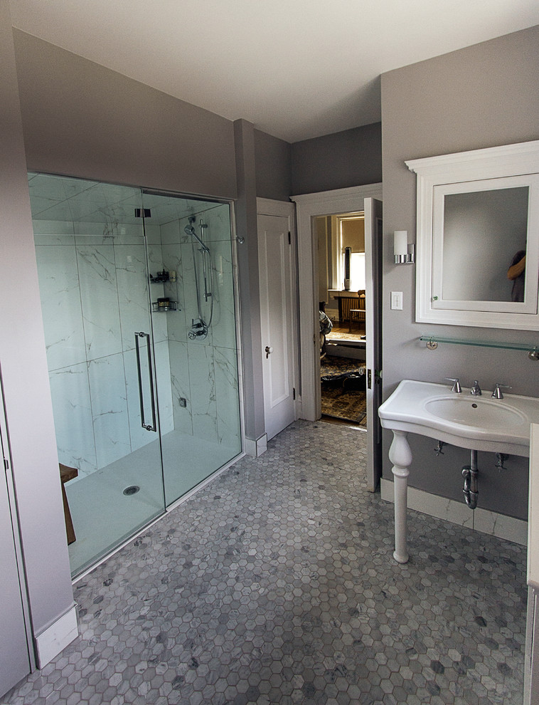 Inspiration for a large traditional master bathroom in Other with a wall-mount sink, a curbless shower, a two-piece toilet, gray tile, stone tile, grey walls, marble floors, glass-front cabinets, white cabinets, solid surface benchtops, grey floor, a hinged shower door and white benchtops.