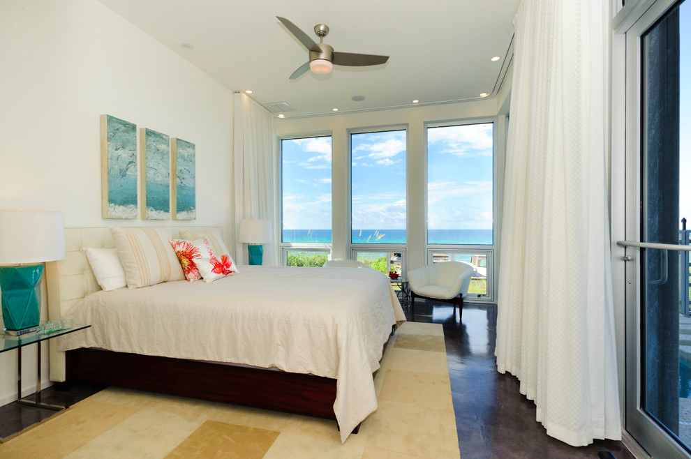 Photo of a tropical master bedroom in Miami with white walls.