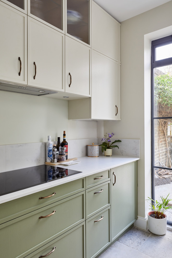 Small transitional l-shaped separate kitchen in London with recessed-panel cabinets, green cabinets, quartzite benchtops, a peninsula and white benchtop.