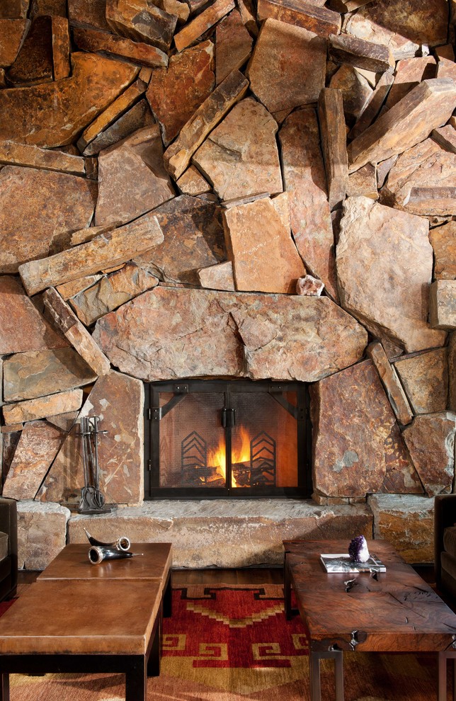 Inspiration for a rustic living room remodel with a stone fireplace