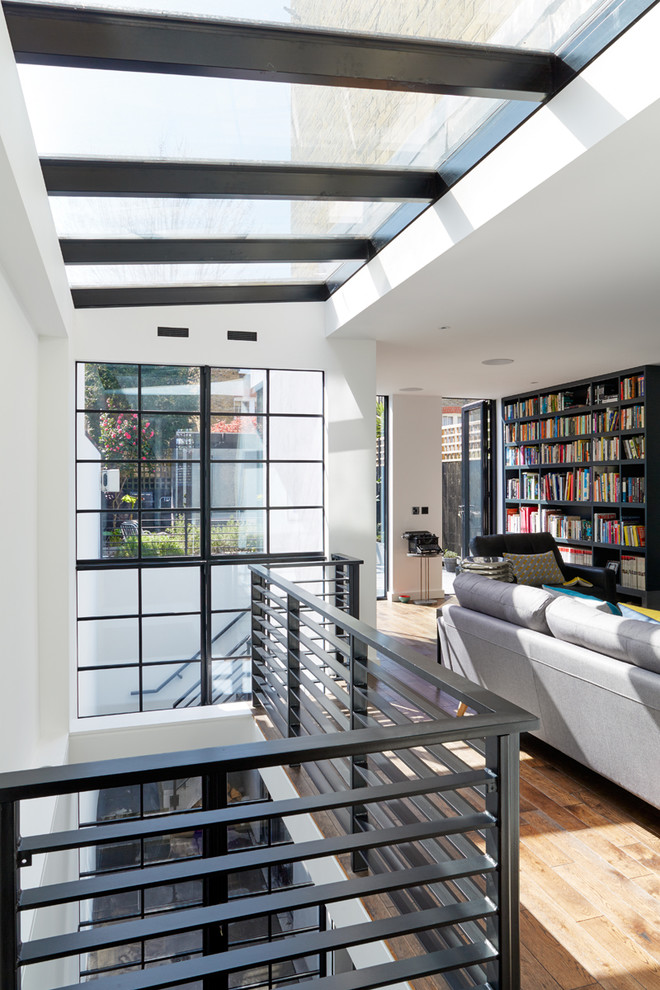 Design ideas for a contemporary family room in London with a library.