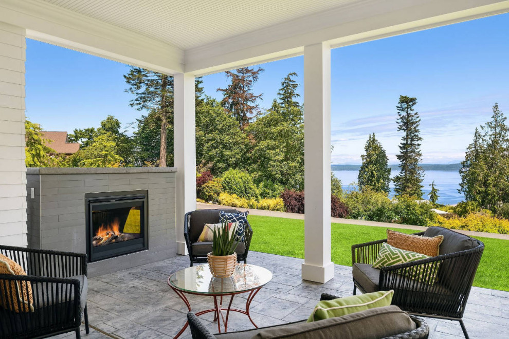 Design ideas for a medium sized nautical side patio in Seattle with a fireplace and a roof extension.