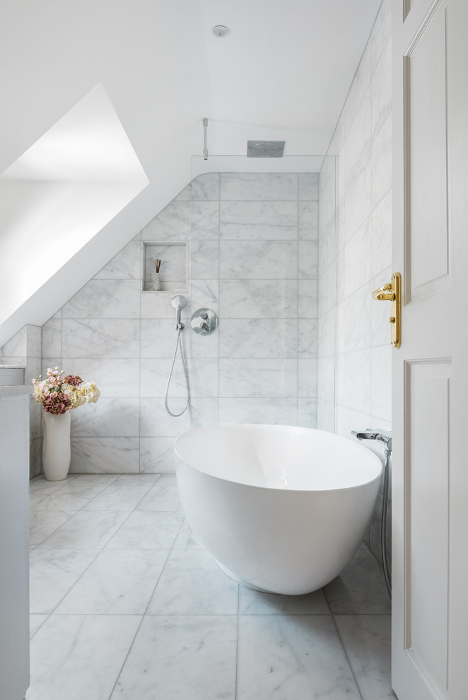This is an example of a mid-sized contemporary master wet room bathroom in Cambridgeshire with a freestanding tub, marble, grey walls, marble floors, white floor, an open shower and gray tile.