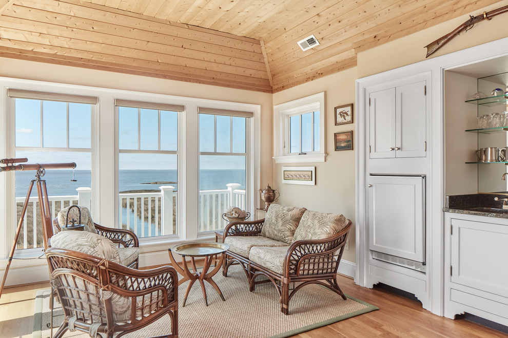 This is an example of a beach style sunroom in Atlanta with light hardwood floors, no fireplace, a standard ceiling and beige floor.