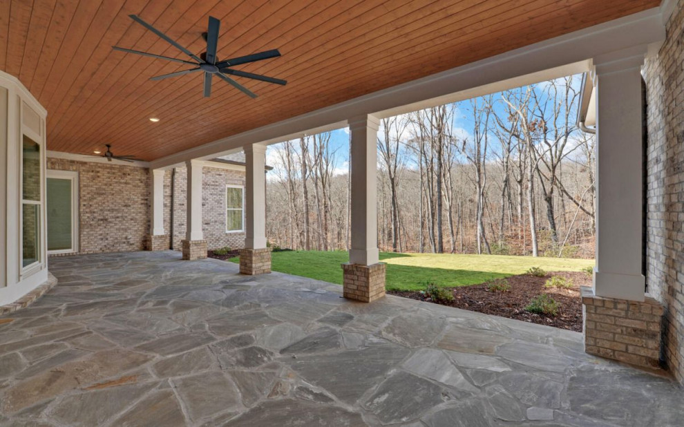 This is an example of a transitional verandah in Atlanta with natural stone pavers.