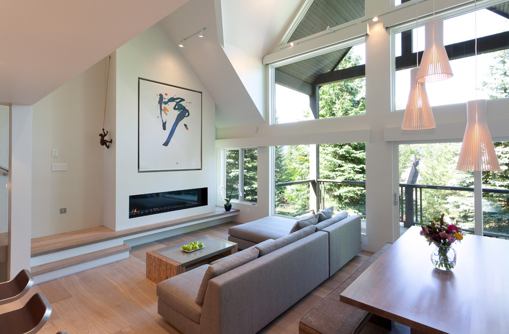 Contemporary open concept living room in Vancouver with white walls.