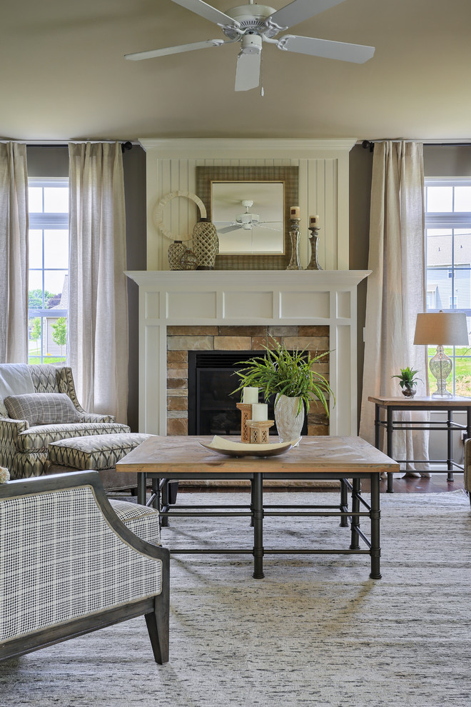 Inspiration for a traditional formal living room in Philadelphia with a standard fireplace, a stone fireplace surround, grey walls and medium hardwood floors.