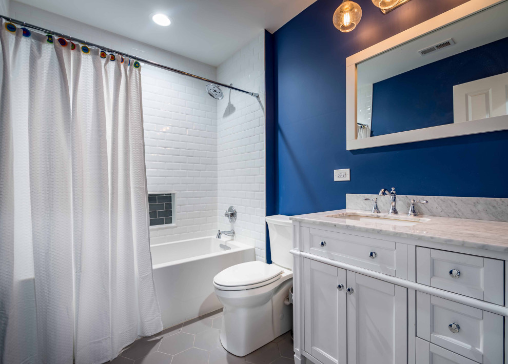 This is an example of a medium sized rural grey and teal shower room bathroom in Chicago with recessed-panel cabinets, white cabinets, an alcove bath, a shower/bath combination, a two-piece toilet, blue tiles, metro tiles, white walls, ceramic flooring, an integrated sink, quartz worktops, multi-coloured floors, a hinged door, multi-coloured worktops, an enclosed toilet, a single sink, a freestanding vanity unit, a wallpapered ceiling and wallpapered walls.