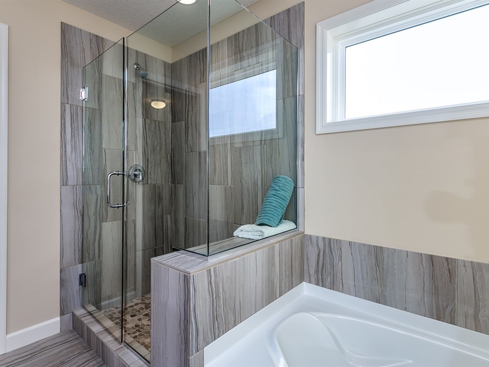 Inspiration for a mid-sized transitional gray tile and porcelain tile porcelain tile drop-in bathtub remodel in Minneapolis with beige walls