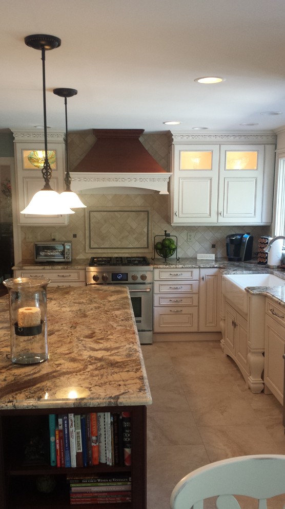 Design ideas for a large traditional u-shaped eat-in kitchen in Baltimore with a farmhouse sink, raised-panel cabinets, white cabinets, granite benchtops, beige splashback, stone tile splashback, stainless steel appliances, porcelain floors and with island.