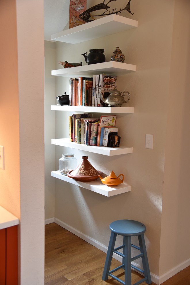 Inspiration for a mid-sized transitional l-shaped light wood floor hallway remodel in Denver with an undermount sink, shaker cabinets, red cabinets, beige backsplash, brick backsplash, stainless steel appliances and a peninsula