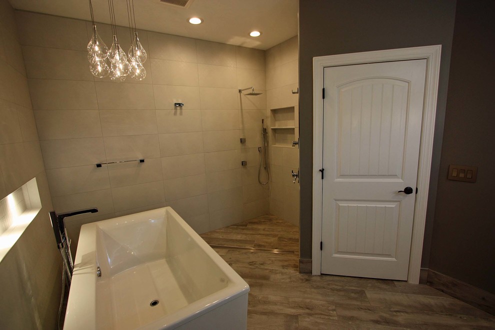 Large contemporary master wet room bathroom in Raleigh with flat-panel cabinets, grey cabinets, a freestanding tub, a one-piece toilet, gray tile, porcelain tile, grey walls, porcelain floors, a vessel sink and quartzite benchtops.