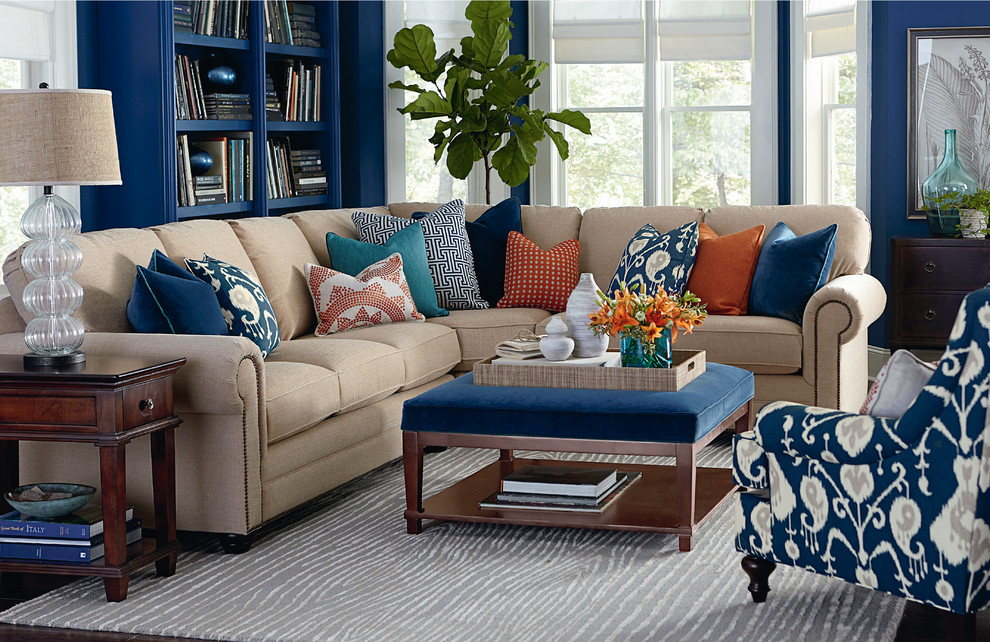Transitional dark wood floor living room photo with blue walls