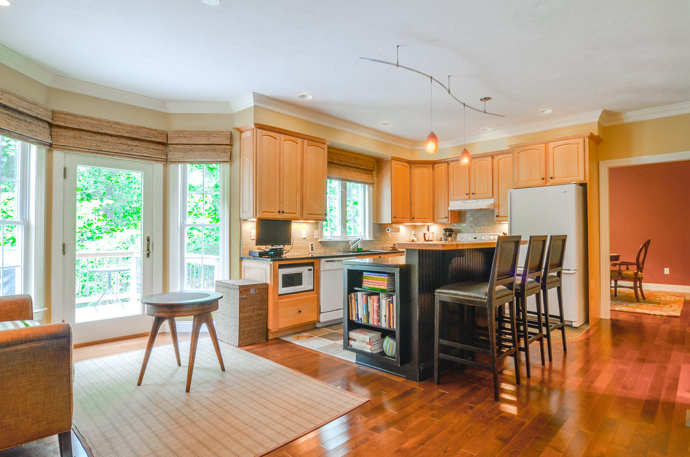 Eat-in kitchen - mid-sized transitional l-shaped medium tone wood floor eat-in kitchen idea in Boston with raised-panel cabinets, medium tone wood cabinets, granite countertops, an island, an undermount sink, beige backsplash, subway tile backsplash and white appliances