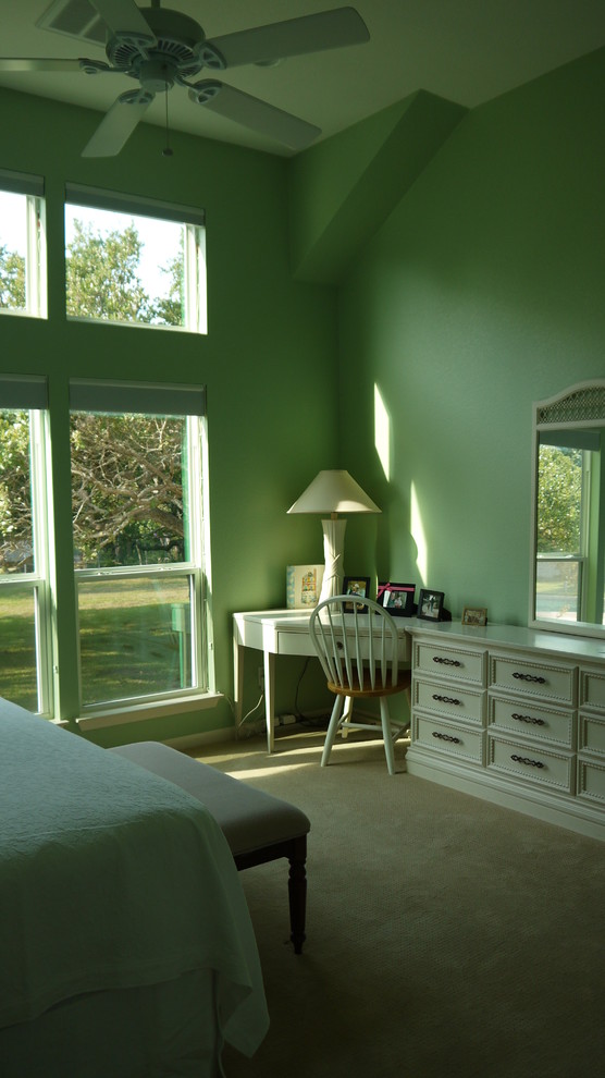 Design ideas for a traditional master bedroom in Austin with green walls and carpet.