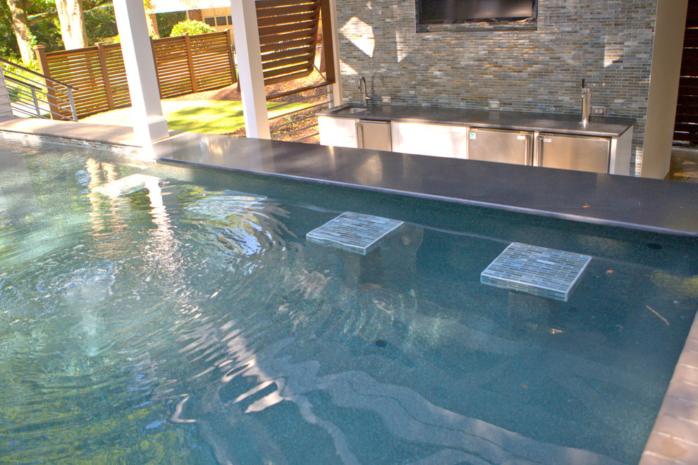 Large trendy backyard custom-shaped and tile natural pool house photo