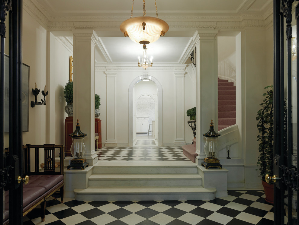Entryway - large transitional entryway idea in New York with white walls and a black front door