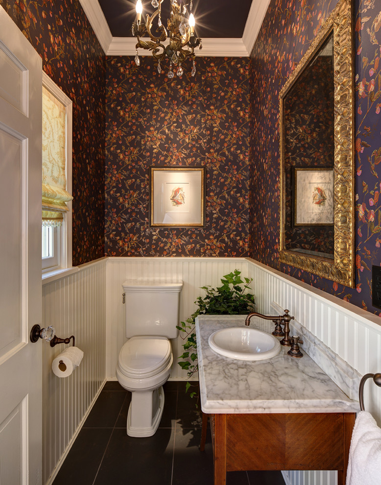 Inspiration for a small traditional powder room in Milwaukee with a drop-in sink, furniture-like cabinets, medium wood cabinets, marble benchtops, purple walls and ceramic floors.