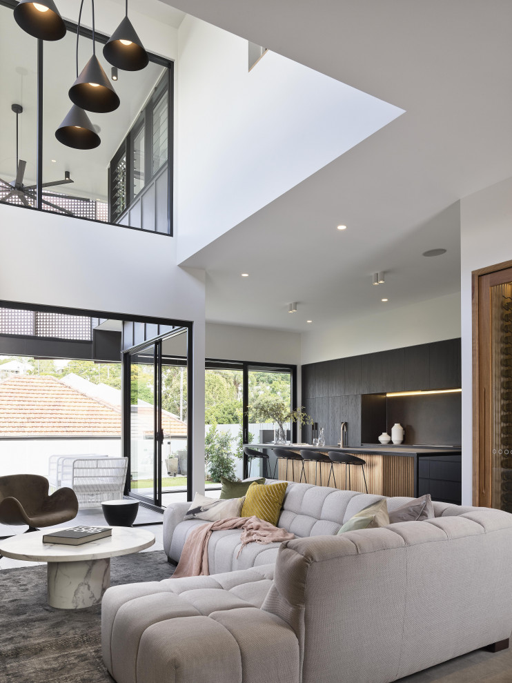 This is an example of a modern open concept living room in Brisbane with white walls.