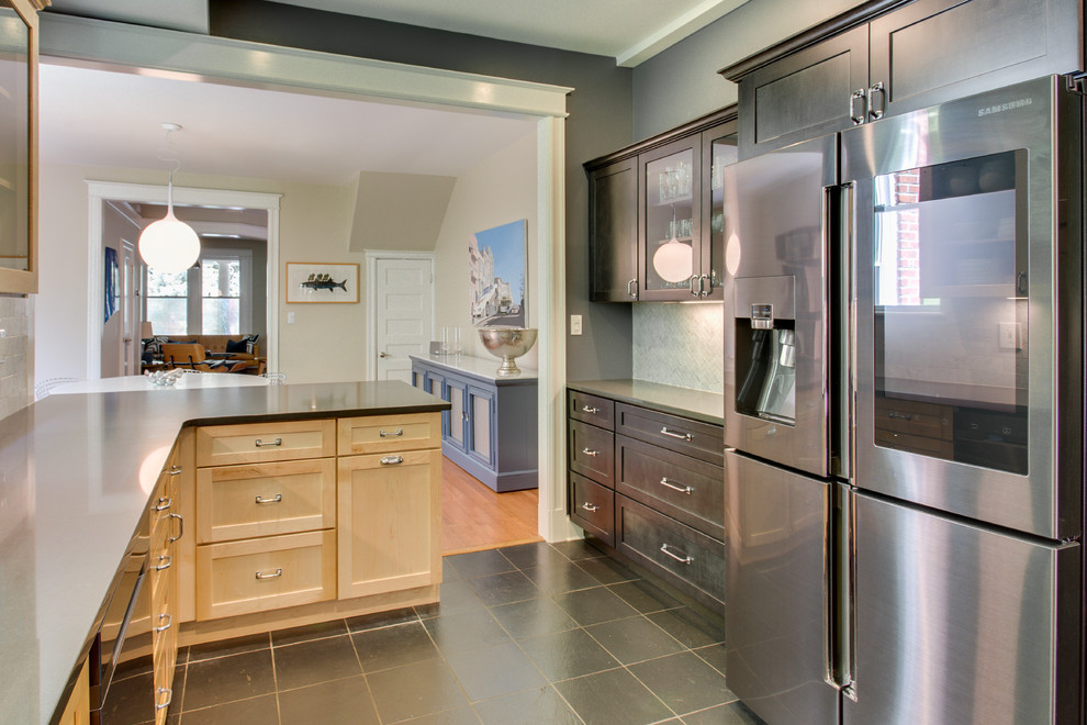 Example of a mid-sized transitional kitchen design in DC Metro with recessed-panel cabinets, quartz countertops, stainless steel appliances and a peninsula