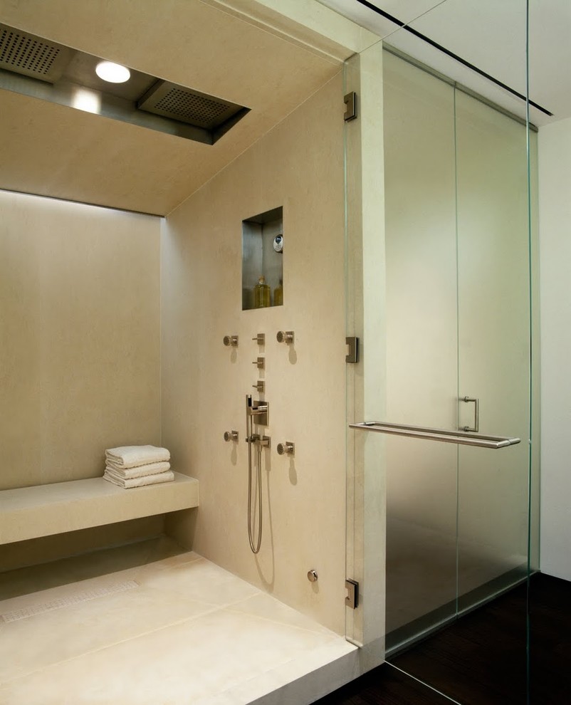 Modern bathroom in New York with an alcove shower, beige tile, limestone, a niche and a shower seat.